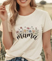 Woman in cream t-shirt featuring pastel floral and butterfly graphic with hand-lettered “mama” – example of DTF Transfers ready to press for moms.
