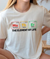 Woman wearing science-themed shirt spelling “Mother” with elements Mo, Th, Er and the phrase “The Element of Life” – perfect DTF Transfers ready to press.
