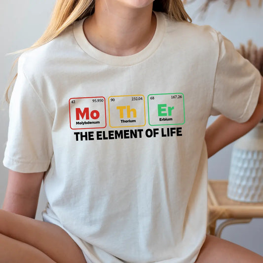 Woman wearing science-themed shirt spelling “Mother” with elements Mo, Th, Er and the phrase “The Element of Life” – perfect DTF Transfers ready to press.
