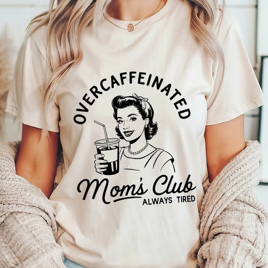 DTF Transfers ready to press design with vintage coffee-drinking mom and the text “Overcaffeinated Mom’s Club – Always Tired” on a white t-shirt.