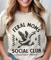 DTF Transfers ready to press featuring “Feral Moms Social Club – Loud and Proud” with a flying goose and grunge-style text on a cream t-shirt.
