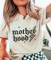 DTF Transfers ready to press – edgy gothic “Motherhood” lightning bolt design in distressed black on a cream t-shirt.