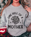 DTF Transfers ready to press – “One Hell of a Mother” tiger design heat transfer on grey sweatshirt.