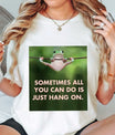 DTF Transfers ready to press – green frog hanging on rope with “Sometimes all you can do is just hang on” text. Funny, motivational design for tees and gifts.