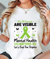 DTF Transfers ready to press – “Not All Wounds Are Visible” green ribbon mental health awareness design with butterflies, shown on a white tee for advocacy wear.