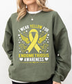 DTF Transfers ready to press – Yellow awareness ribbon with wings and hearts, featuring “I Wear Yellow for Endometriosis Awareness” text on green sweatshirt.

