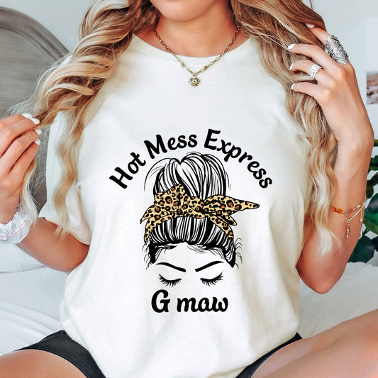Messy bun with leopard-print bandana and “Hot Mess Express G-maw” slogan DTF Transfer design on white t-shirt.