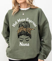 Olive-green sweatshirt mockup featuring messy bun with leopard-print bandana and “Hot Mess Express Nana” slogan DTF Transfer design.