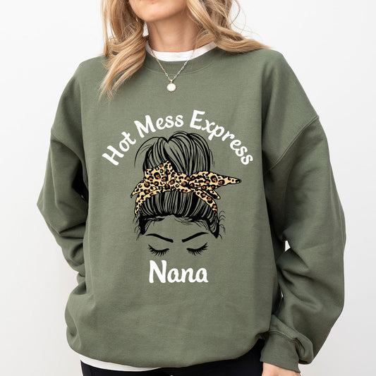 Olive-green sweatshirt mockup featuring messy bun with leopard-print bandana and “Hot Mess Express Nana” slogan DTF Transfer design.
