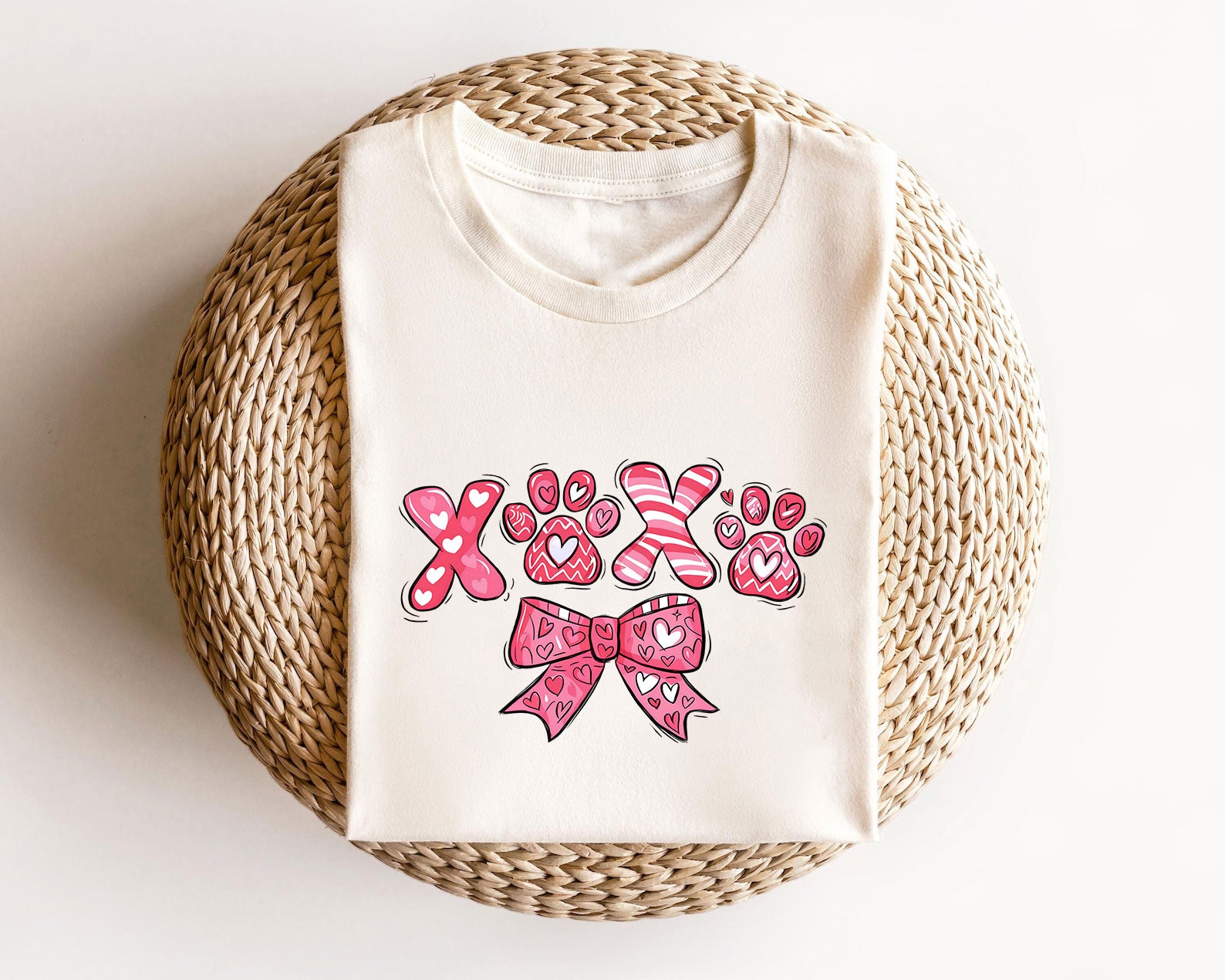 XOXO Paw Prints ready-to-press DTF transfer design with heart-filled letters, paw prints, and a pink bow.