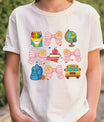 White T-shirt with pastel school-themed DTF transfer design featuring pink bows and school icons.