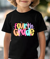 Black T-shirt with colorful “Fourth Grade” DTF transfer design featuring large bright bubble letters and flower accents.