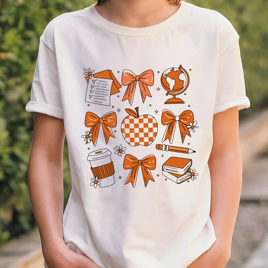 White T-shirt with orange and white school-themed DTF transfer featuring bows, apple, globe, pencil, and books.