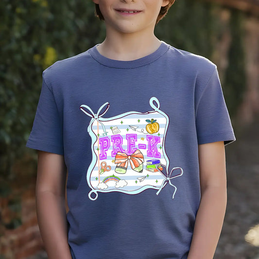 Navy-blue T-shirt with “Pre-K” DTF transfer design featuring big pink letters in a tied frame with cute school icons like rainbow, scissors, books, and pumpkin.