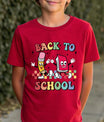 Red T-shirt with “Back to School” DTF transfer design featuring colorful cartoon pencil and book characters with multicolored block text.