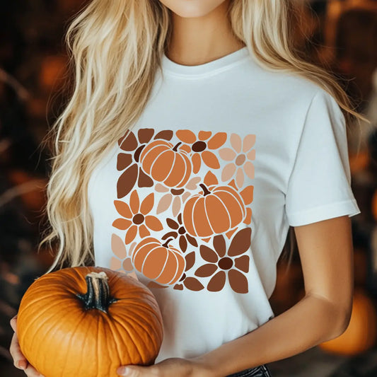 White T-shirt with modern “Pumpkin Floral Pattern” DTF transfer design featuring stylized pumpkins and flowers in warm fall colors.