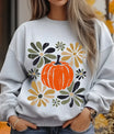 Gray sweatshirt with “Rustic Pumpkin & Flowers” DTF transfer design featuring a large orange pumpkin surrounded by hand-painted fall flowers in muted tones.