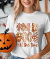 White T-shirt with “God Is Good All the Time” DTF transfer design featuring floral-patterned letters, bows, and autumn-inspired accents.