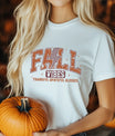 White T-shirt with “Fall Vibes Thankful Grateful Blessed” DTF transfer design featuring bold collegiate text and a checkered lightning bolt.