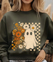 Green sweatshirt with DTF transfer design featuring a cute ghost, vintage orange and cream flowers, and distressed checkered background.