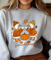 Gray sweatshirt with “GooseBumps” DTF transfer design featuring two autumn-dressed ducks fist-bumping over a pumpkin with falling leaves.