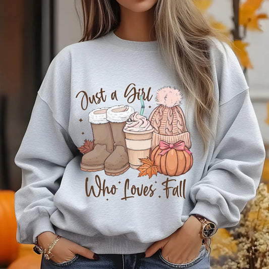 Gray sweatshirt with “Just a Girl Who Loves Fall” DTF transfer design featuring cozy fall boots, coffee, beanie, pumpkin with bow, and autumn leaves.