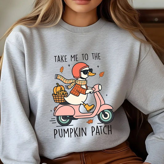 Gray sweatshirt with colorful fall-themed “Take Me to the Pumpkin Patch” DTF transfer design featuring a duck on a scooter carrying pumpkins.