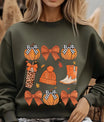 Green sweatshirt with cozy fall DTF transfer design featuring pumpkins, gingham bows, knit beanie, boots, and leopard-print tumbler, ideal for autumn apparel.