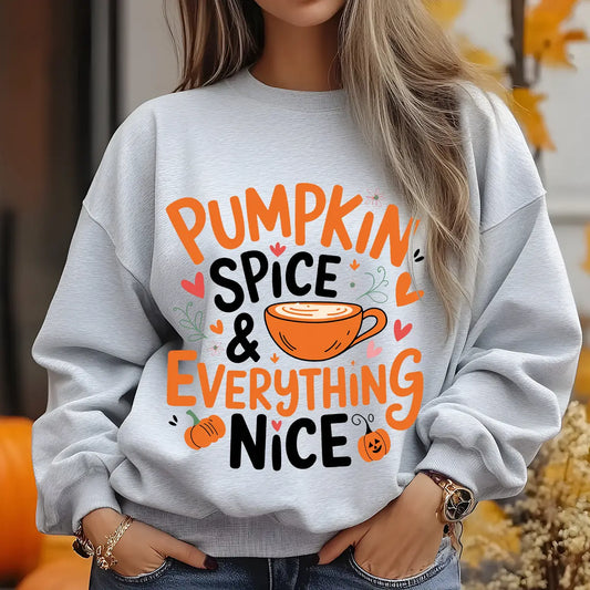 Gray sweatshirt with “Pumpkin Spice & Everything Nice” DTF transfer design featuring orange lettering, a coffee cup, hearts, and pumpkins, perfect for fall apparel.