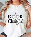 Natural t-shirt with black “Book Club Babe” DTF transfer design featuring heart-shaped glasses, perfect for stylish book lovers.