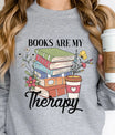 Gray sweatshirt with “Books Are My Therapy” DTF transfer design featuring stacked books, flowers, and coffee cup—ideal for cozy book lovers.