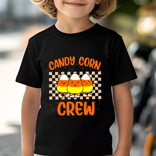 Black t-shirt with design featuring three smiling candy corns wearing sneakers, checkerboard background, and bold orange text “Candy Corn Crew.”
