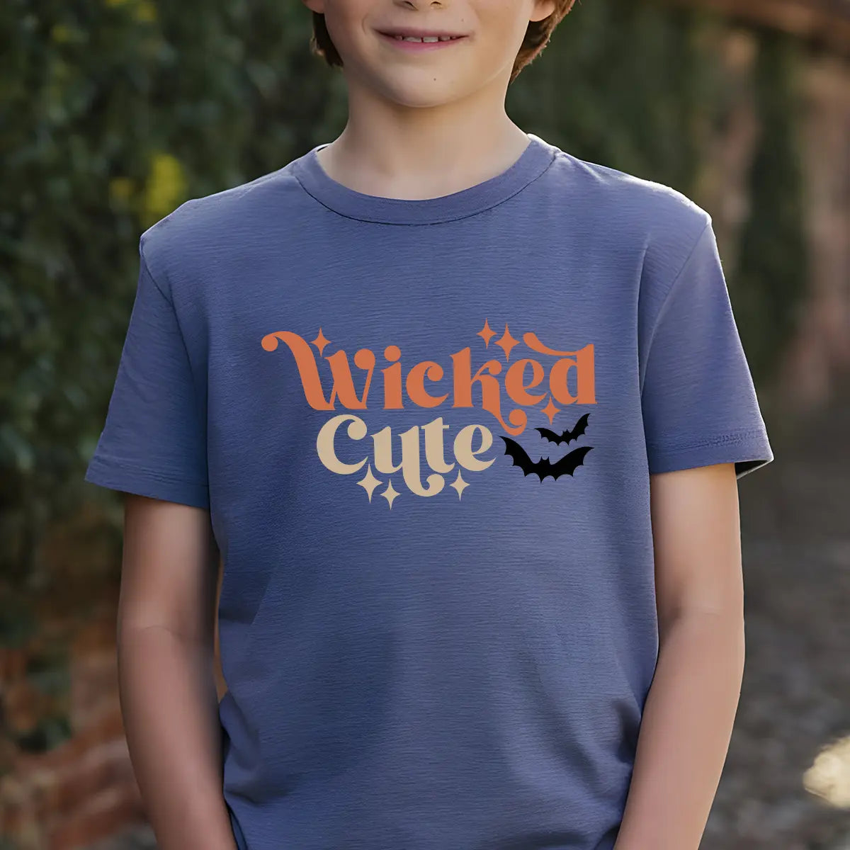 Navy t-shirt with retro orange and cream “Wicked Cute” lettering, sparkles, and a black bat graphic DTF transfer design, perfect for kids’ Halloween apparel.