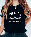 Black t-shirt with bold white text “I’ve Got a Good Heart But This Mouth” DTF transfer design, funny and sassy quote shirt.