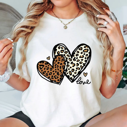 Natural t-shirt with two overlapping leopard print hearts and “love” script DTF transfer design, trendy and stylish heart-themed apparel.