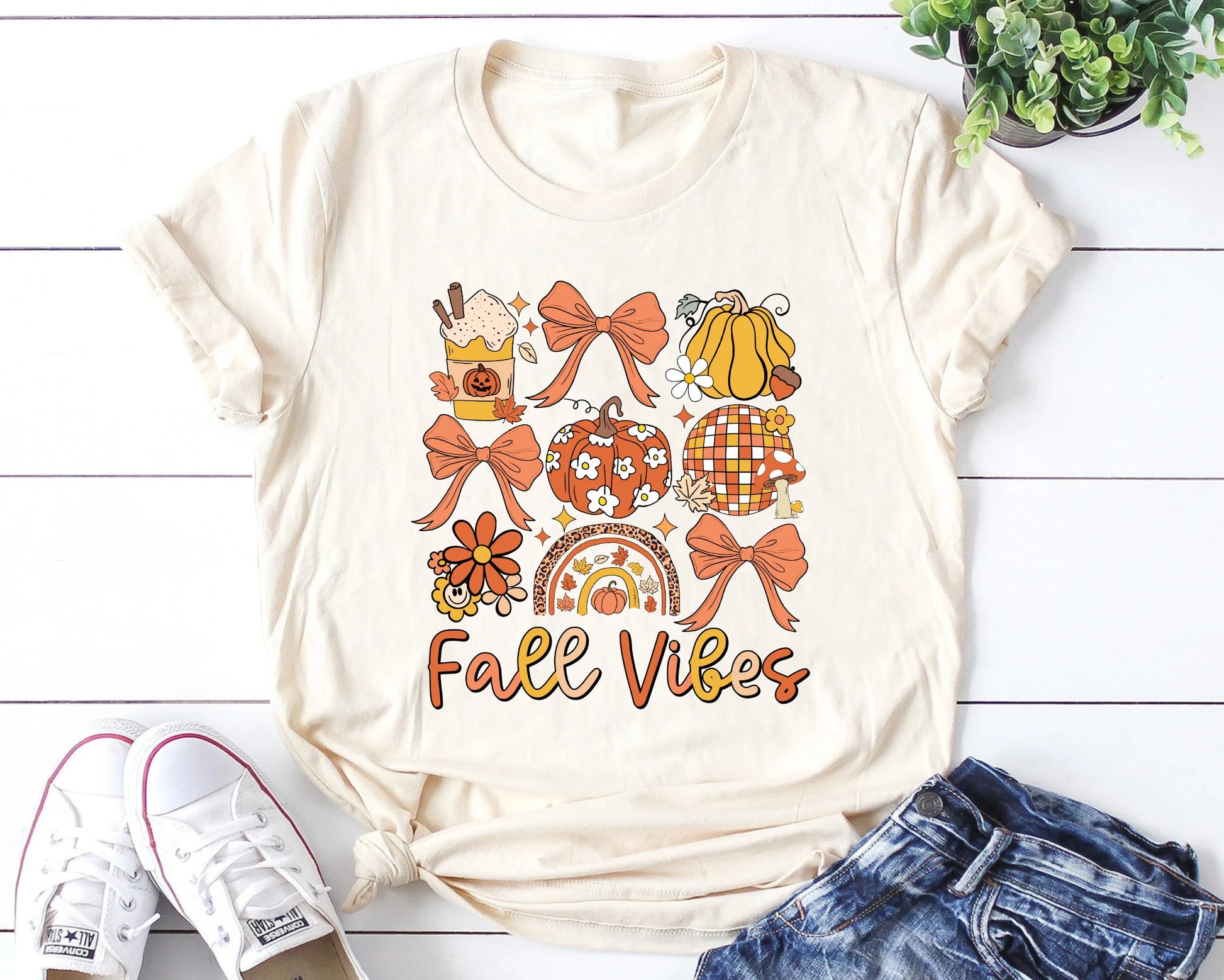 Cream t-shirt with 'Fall Vibes' DTF transfer featuring autumn-themed icons like pumpkins and leaves