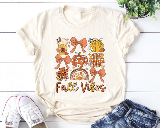 Cream t-shirt with 'Fall Vibes' DTF transfer featuring autumn-themed icons like pumpkins and leaves