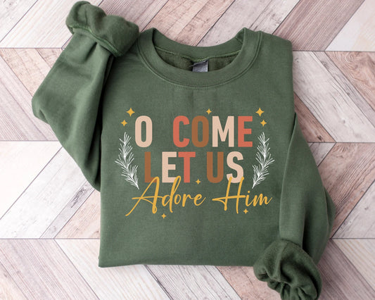 Green sweatshirt with 'O Come Let Us Adore Him' DTF transfer, featuring elegant typography and botanical accents