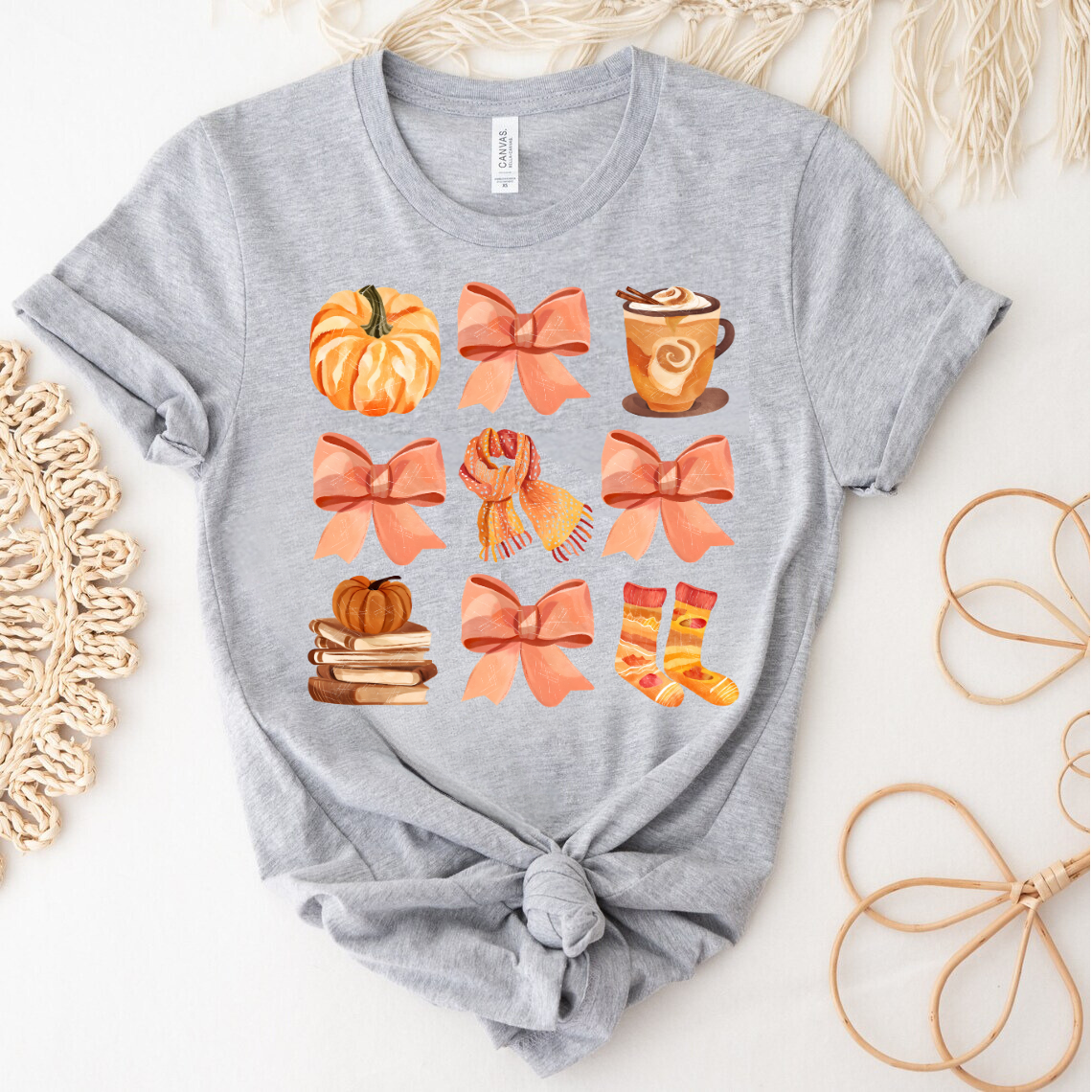 Grey t-shirt with 'Autumn Essentials' DTF transfer featuring fall-themed items like pumpkins, socks, and hot drinks