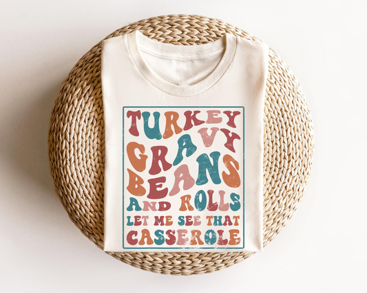 Cream sweatshirt with 'Turkey Gravy Beans and Rolls' Thanksgiving-themed DTF transfer in colorful lettering