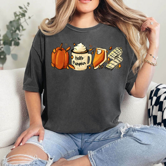 Woman wearing a charcoal gray t-shirt with 'Hello Pumpkin' DTF transfer including pumpkin, coffee, and scarf illustrations