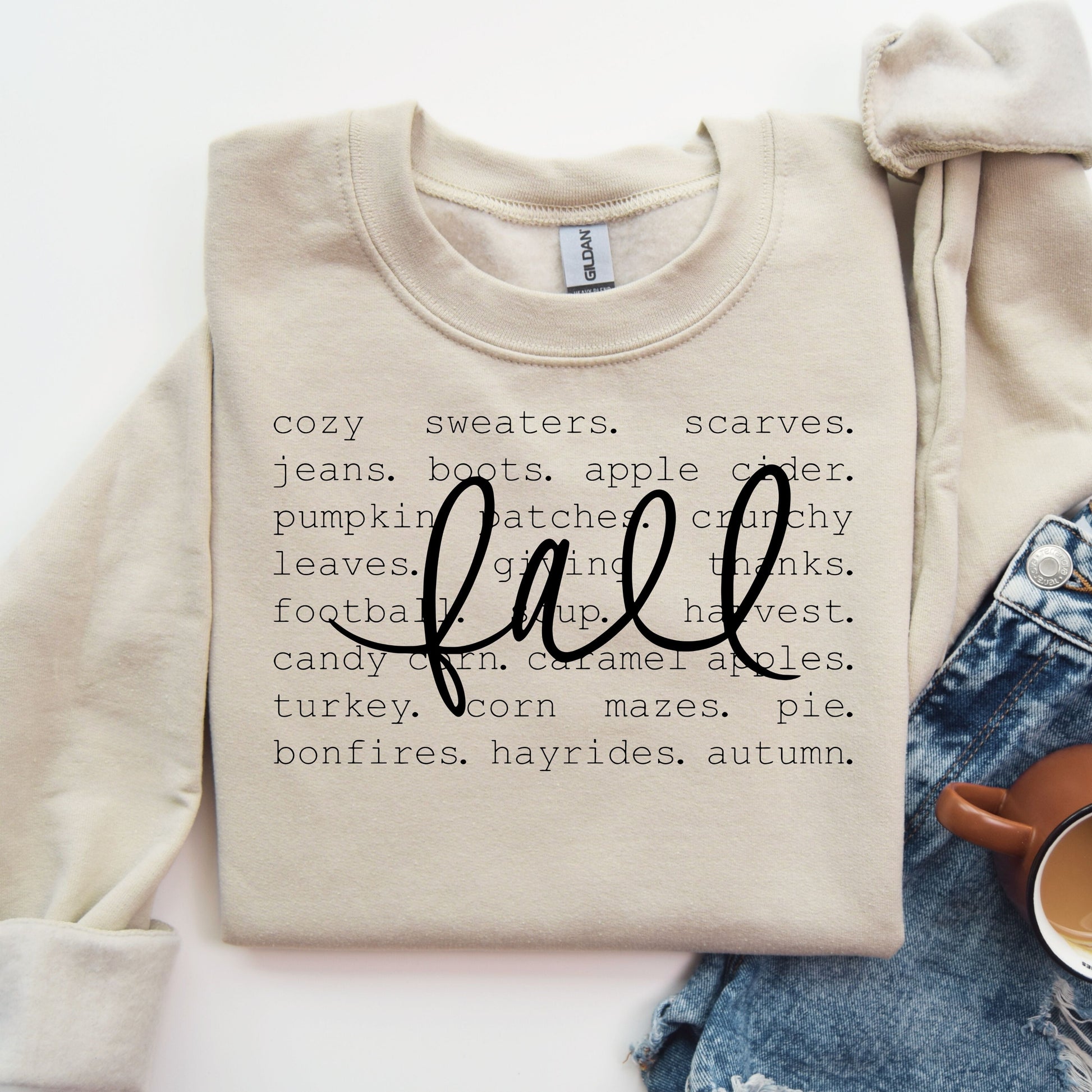 Neutral tone sweatshirt with 'Fall Checklist' DTF transfer listing autumn favorites like sweaters, scarves, and pumpkin patches