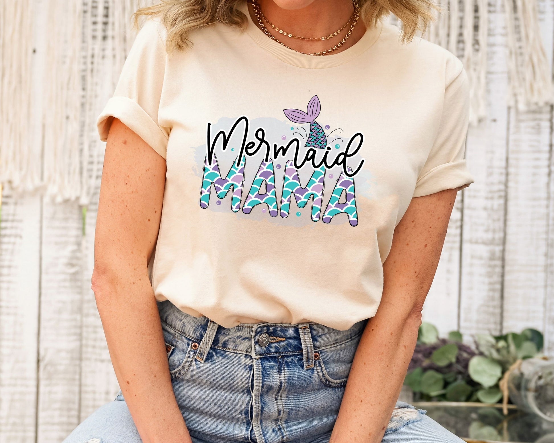 Mermaid Mama ready-to-press DTF transfer design on a beige shirt with mermaid scales and sea details.