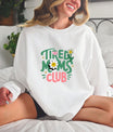 Smiling woman wearing a white sweatshirt with a Tired Moms Club DTF Transfer featuring a cute floral and retro-style design.