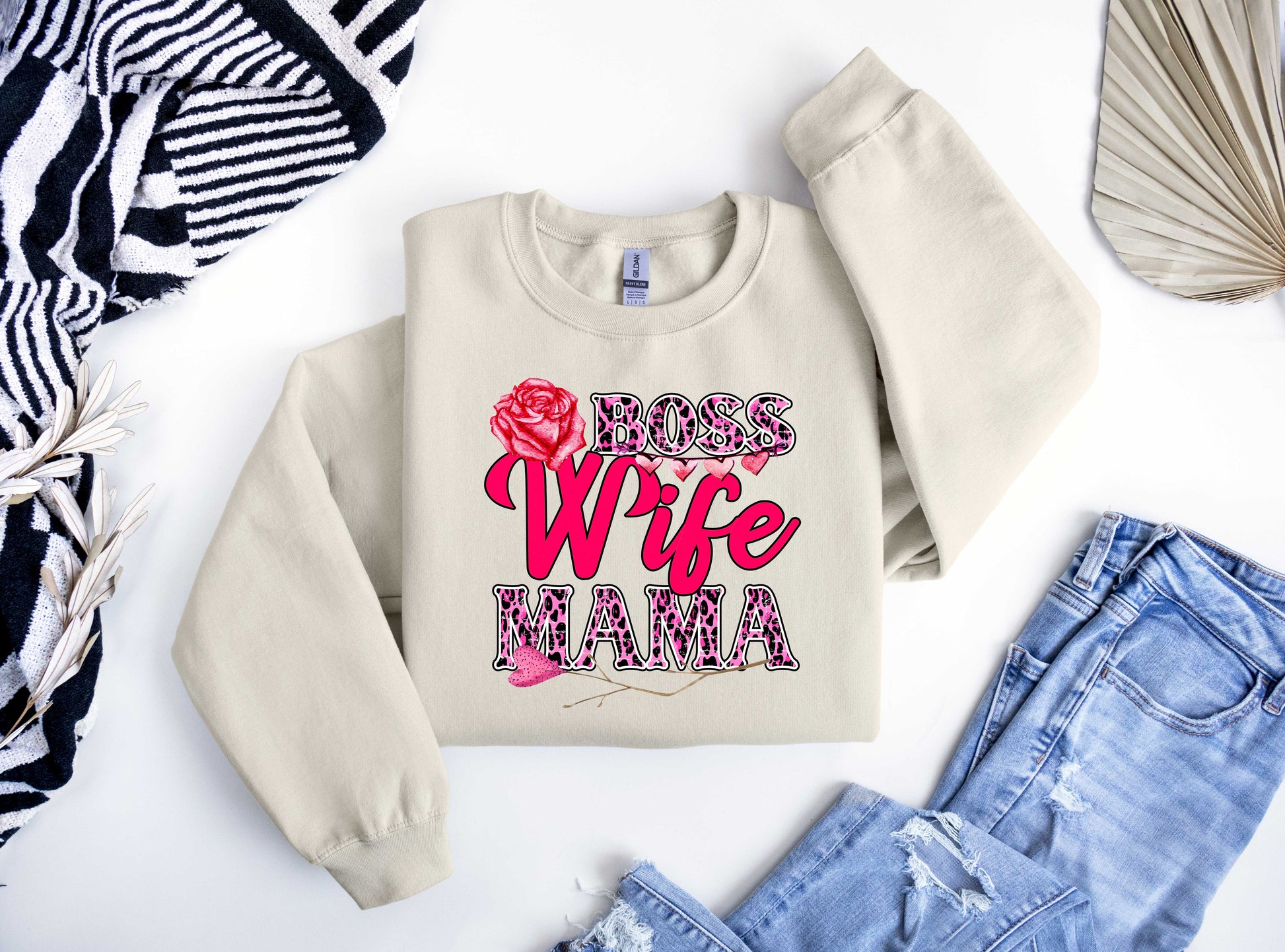 Beige sweatshirt featuring a bold "Boss Wife Mama" design with pink leopard print accents and a red rose, perfect for Mother’s Day fashion.