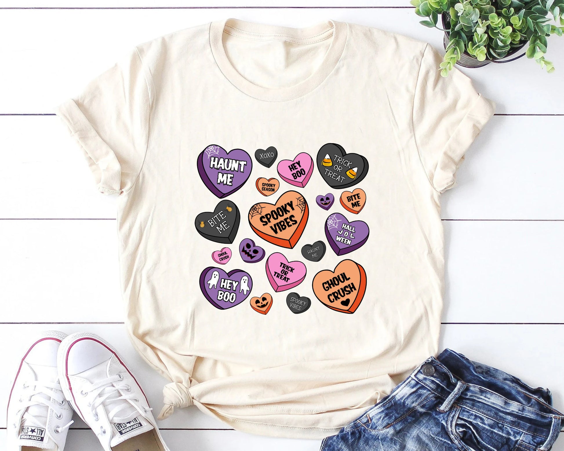 "Spooky Vibes Candy Hearts" DTF transfer design on a cream t-shirt featuring colorful candy hearts with Halloween sayings like "Haunt Me" and "Ghoul Crush."