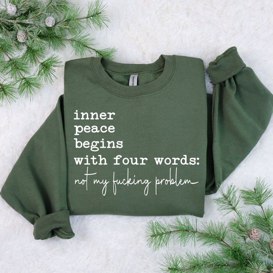 "Inner Peace Four Words" DTF transfer design on a green sweatshirt featuring bold white text with a humorous self-care message.