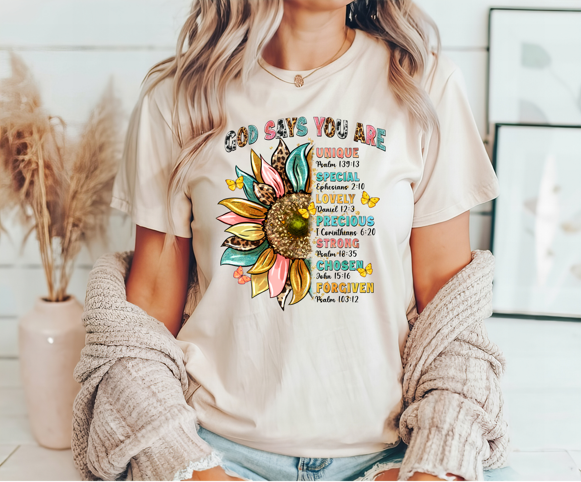 "God Says You Are" DTF transfer design on a white t-shirt featuring a colorful sunflower, scripture references, and uplifting text.