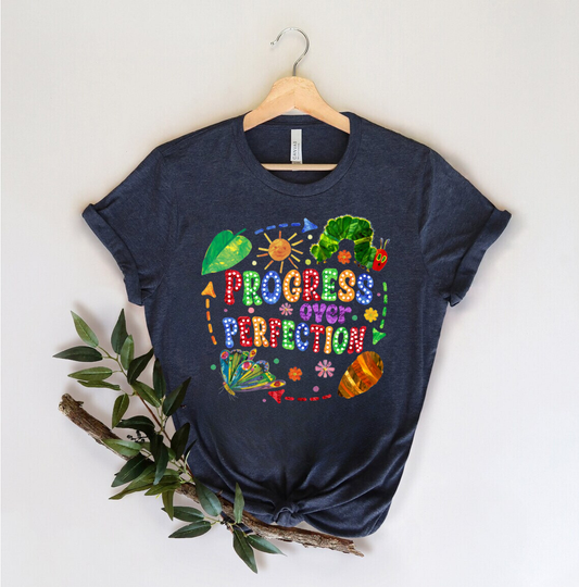 "Progress Over Perfection" DTF transfer design on a navy t-shirt featuring a colorful caterpillar-to-butterfly transformation and motivational phrase.