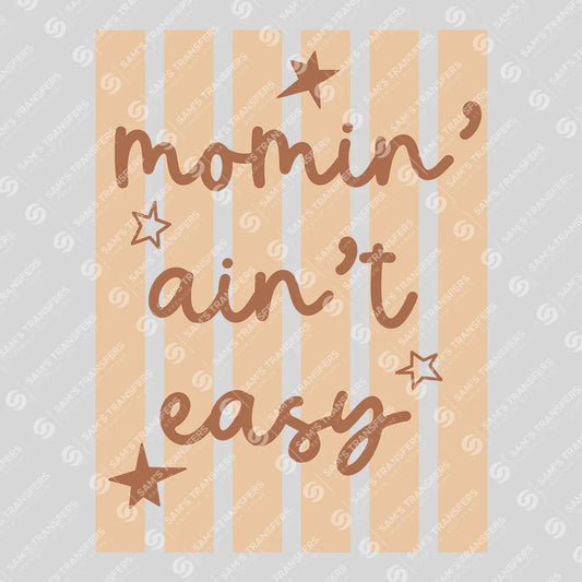 Apparel featuring a Momin Ain't Easy-themed DTF transfer.
